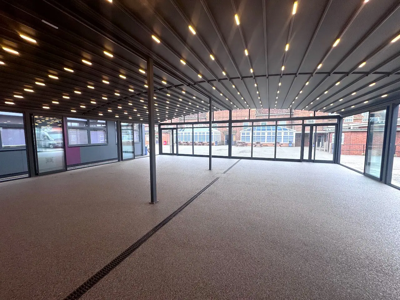 Retractable roof canopy for a school outdoor area