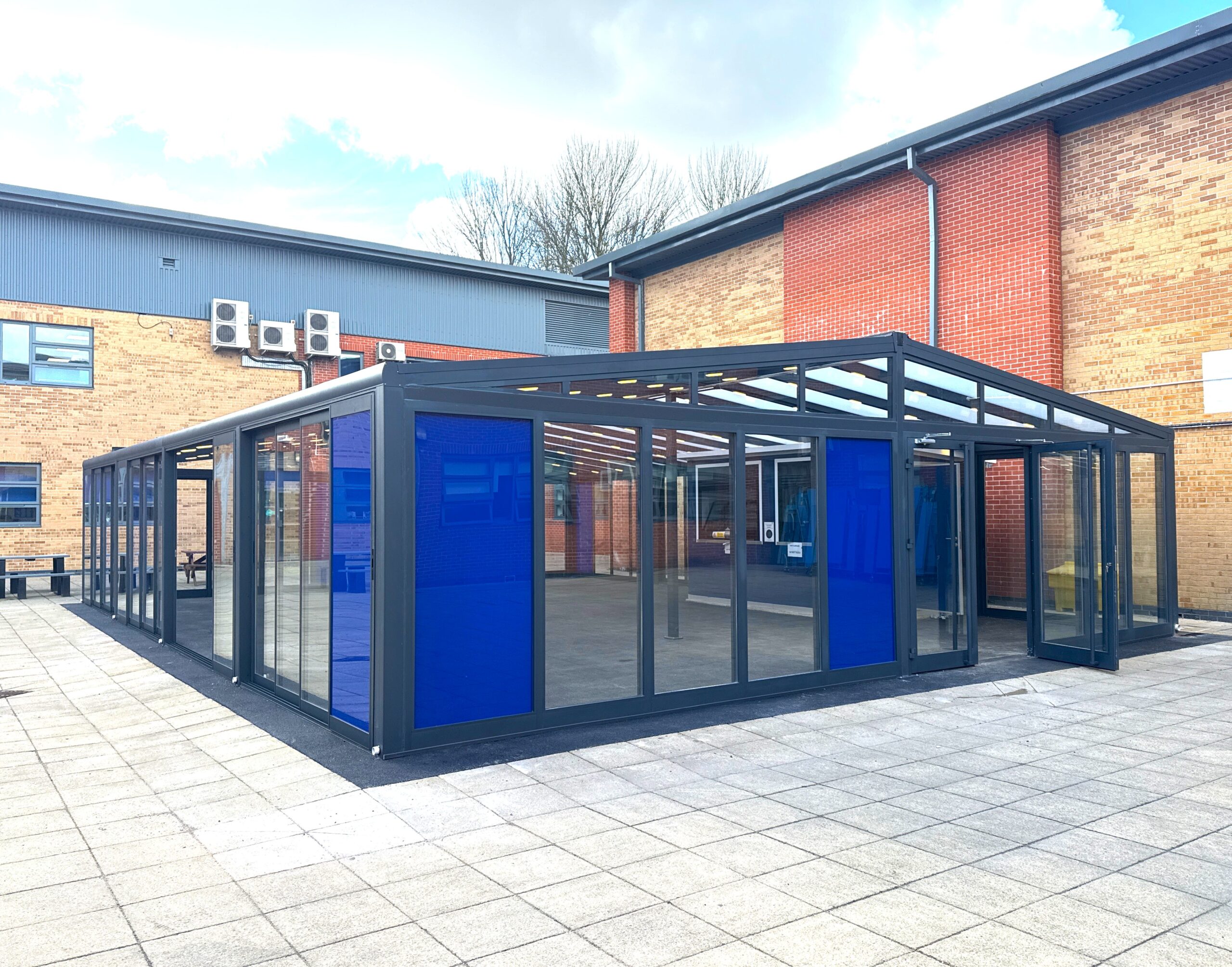 Enclosed school canopy with glazed panels and doors